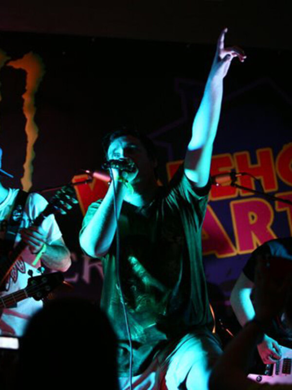 Band on stage at the Monster Energy warehouse party
